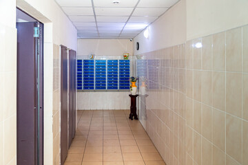 A lot of new mailboxes in an apartment building. New building, mailboxes in the lobby of an apartment building