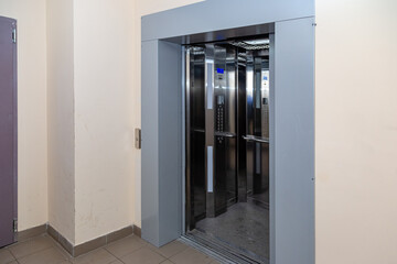 The elevator entrance is in modern office with marble wall. Lift transportation floor to floors with push switch for up and down. © Александр Бутылов