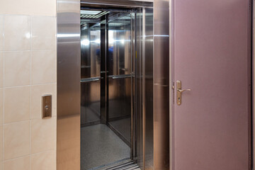 The elevator entrance is in modern office with marble wall. Lift transportation floor to floors...
