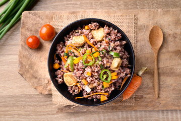 Fried purple rice with tofu, carrot, pumpkin and chili pepper. Healthy Asian vegan food, Table top view