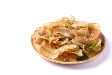 Banana chips or banana crisps on wooden plate with white background, Delicious snack