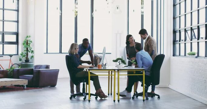 Every team members input is valuable. Diverse group businesspeople working together in a modern office. Group of businesspeople collaborating and brainstorming together in the office using computers