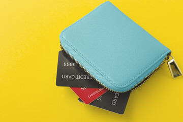 Credit cards in wallet on yellow background - obrazy, fototapety, plakaty