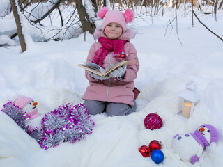 Obraz na płótnie Canvas Portrait of a girl in a New Year's snowy winter forest.