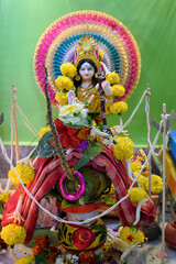 Idol of Goddess Devi Saraswati with pooja samagri or ingredients. Close Up. Selective focus.