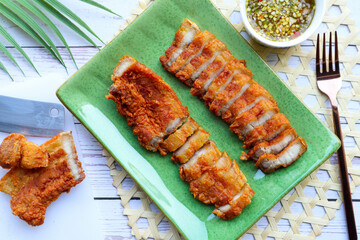 Deep fried pork belly with spicy sauce  - Flat lay food in Thai called Moo Sam Chan Tord