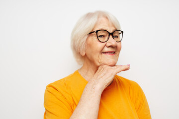 Portrait of an old friendly woman vision problems with glasses light background