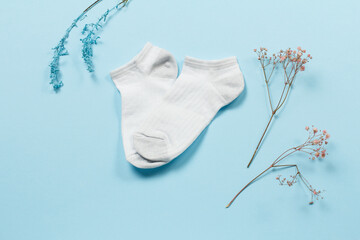 Pair of women socks on blue background.