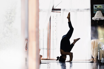 Image of beautiful woman practicing indoor yoga, beautiful girl practicing cobra asana in class,...