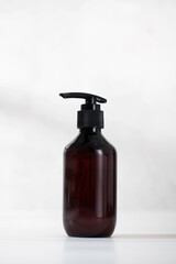 A mock-up of an organic cosmetic product in a brown dispenser on a light background. 