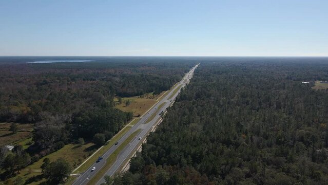 Aerial drone view overlooking traffic on U.S 301, in sunny Waldo, Florida, USA