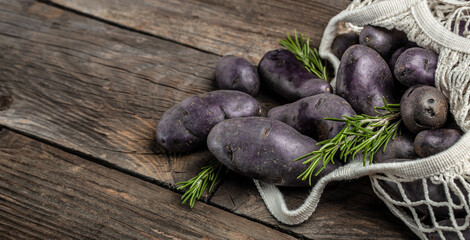 Organic purple sweet potato. Raw sweet potatoes or batatas. pomoea batatas. Batata potato. vegan food ingredient. banner, menu, recipe place for text, top view