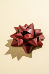 Photo of a gift bow on a beige background.