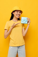 woman with Asian appearance with a gift box in his hands surprise emotions isolated background unaltered