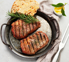 Grilled steak on light background. Homemade food concept.