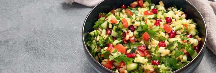 Fresh Tabbouleh salad on dark background.