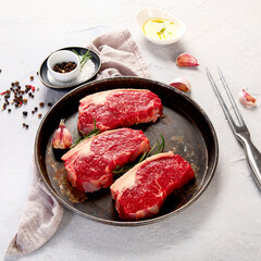 Grilled fish, seafood and meat assortment on light background.