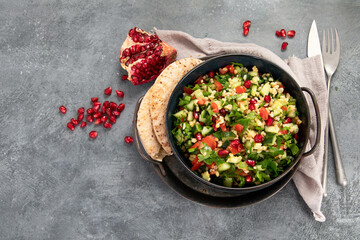 Fresh Tabbouleh salad on dark background.