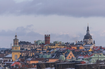 Fototapeta premium Panorama view over parts of the old houses, towers and buildings in the district Södermalm a cold sunny winter day in Stockholm