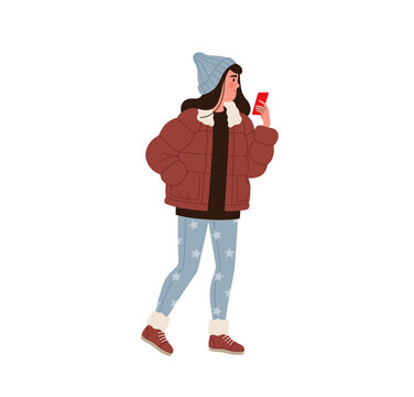Girl or woman in modern winter clothes with a smartphone in her hands stands on the street. Young woman in a jacket, hat and jeans with a star pattern chatting online