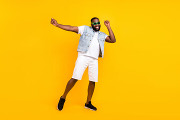 Full length body size view of attractive funky cheerful guy dancing having fun isolated over bright yellow color background