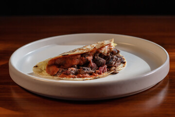 Quesadilla with meat on a white plate