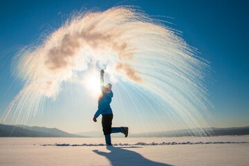 boiling water in the cold, happy woman on a walk in winter,