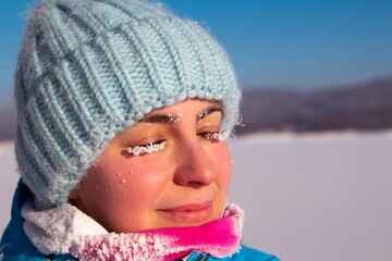 woman with frost eyelashes on a frosty winter day, outdoors