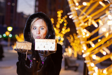 Woman on the background of night christmas illumination