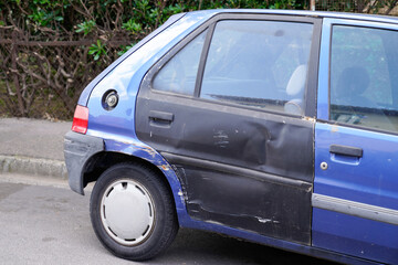 car old bodywork with damage on accident with dent old and used dented striped side rear door - obrazy, fototapety, plakaty