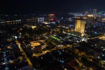 Fototapeta na wymiar Top View of Building in a City - Aerial view Skyscrapers flying by drone of Phnom Penh city with downtown , riverside and sunset