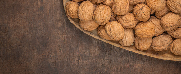 Walnuts on dark wooden  table. Fresh nuts kernels closeup