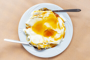 cottage cheese or curd with honey on a plate as a traditional dessert