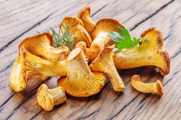 Golden chanterelle mushrooms on the old wooden table.