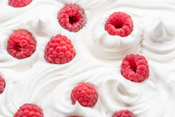 Fresh raspberries in the yoghurt or cream. Top view.