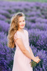 Fototapeta na wymiar Portrait of a beautiful girl with long hair in a lavender field