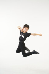 Fototapeta na wymiar A boy in a national Caucasian outfit jumping on a white background. Traditions, culture and customs of the Eastern peoples.