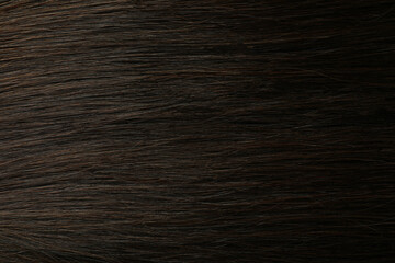 Naklejka premium Dark female hair on whole background, close up
