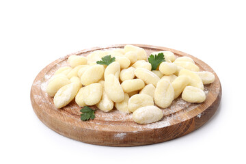 Round board with raw potato gnocchi isolated on white background