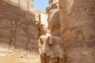Egypt Luxor Temple. granite Statue of Ramses II seated in front of columns