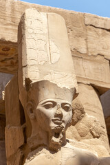 Egypt Luxor Temple. granite Statue of Ramses II seated in front of columns