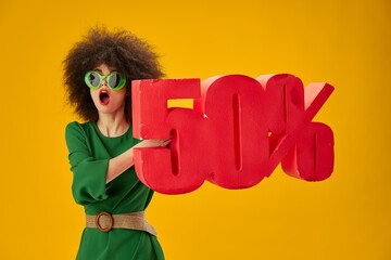 Pretty young female green dress afro hairstyle dark glasses fifty percent in hands studio model unaltered