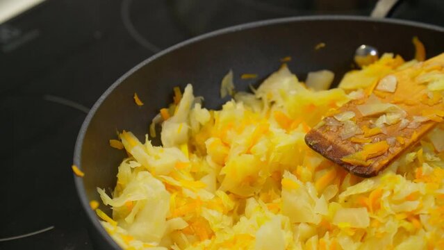 Stewed cabbage is prepared in a frying pan. Selective focus