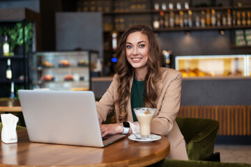 Business Woman Restaurant Owner Use Laptop In Hands Dressed Elegant Pantsuit Sitting Table In Restaurant With Bar Counter Background