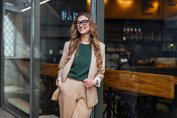 Obraz premium Business Woman Restaurant Owner Dressed Elegant Pantsuit Standing Near Restaurant Big Window