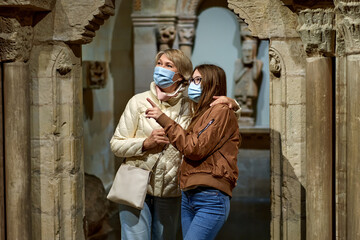 Woman and child looking old artworks in historical museum