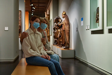 Fototapeta na wymiar woman visitor with daughter looking to art in museum