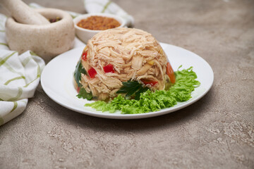 Delicious chicken aspic on a plate on concrete table