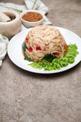 Delicious chicken aspic on a plate on concrete table