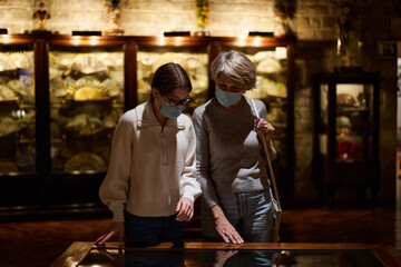 Woman and his daughter view the artworks
